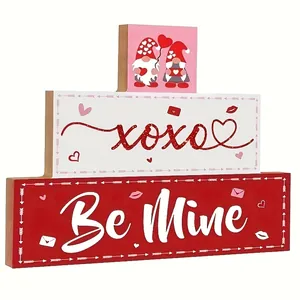 Detailed view of a three-tier wooden Valentine's Day sign with cute gnomes and XOXO