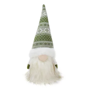 Close-up detail of festive knitted Christmas gnome doll with soft plush beard and green hat