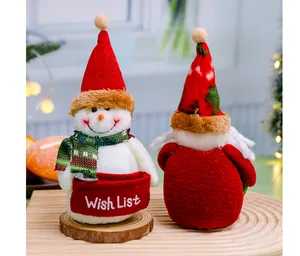 Detailed view of plush Christmas snowman and Santa dolls with embroidered Wish List pocket