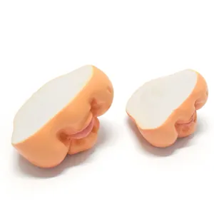 Detail view of two flesh-toned resin gnome nose and mouth accessories for DIY dolls