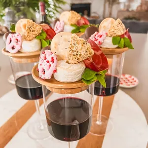 Bamboo wine glass topper used as a charcuterie board for appetizers