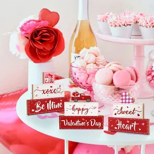 Valentine's Day wooden tabletop signs with romantic text in a party setting decor