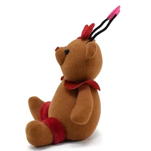 Side view detail of a cute brown flocked teddy bear figurine with red heart accents