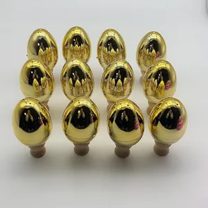 Row of shiny electroplated golden plastic Easter eggs with wooden display stands