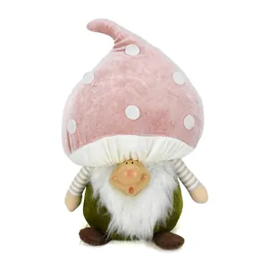 Vista dettagliata di uno gnomo fungo di peluche con cappello a pois rosa e viso in resina.