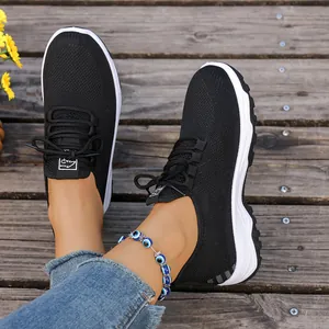 Breathable black mesh walking shoes for seniors with comfortable soft soles worn outdoors