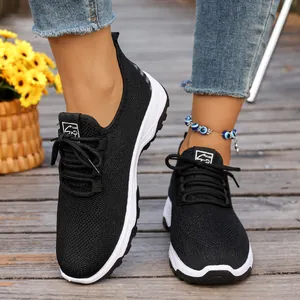 Detailed shot of breathable black mesh walking shoes with lightweight soft white sole