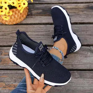 Navy blue breathable mesh walking shoes for seniors with lightweight soft white soles.