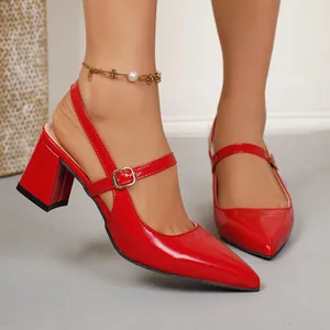 Detailed view of red pointed-toe slingback heels with chunky heels and ankle strap