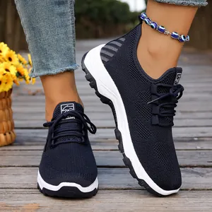 Dark blue breathable mesh walking shoes for seniors featuring flexible white soles.