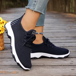 Detail shot of breathable navy mesh walking shoes for seniors on a wooden boardwalk