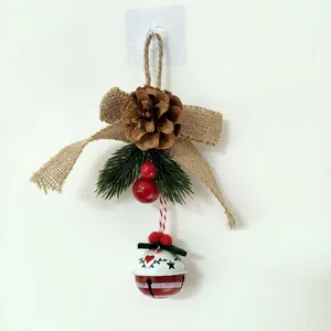 Detailed view of a rustic Christmas bell ornament with pine cone and burlap bow