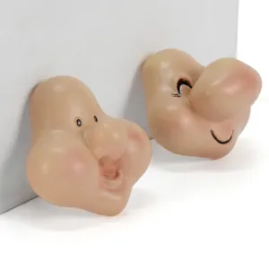 Detailed view of resin dwarf gnome face accessories featuring two unique facial expressions