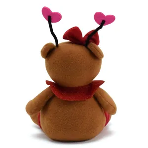 Detailed back view of cute brown teddy bear plush with red bow and pink heart antennae
