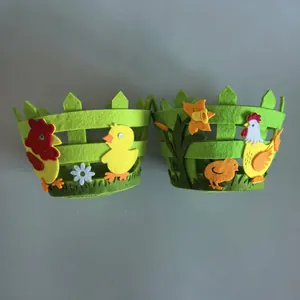 Detailed view of two green Easter felt baskets with colorful chicken applique decor