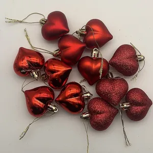 Detailed view of red heart ornaments in glossy, matte, and glitter textures, set of 12.
