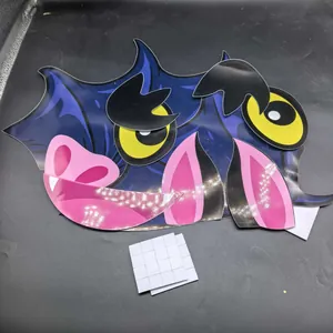 Close-up of DIY Halloween monster face trunk stickers with double-sided adhesive pads