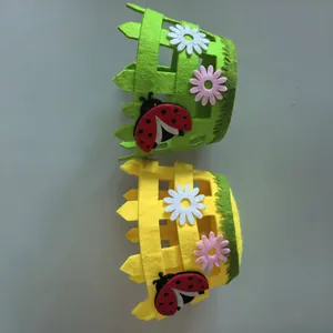 Handmade Easter felt baskets featuring flower and ladybug decor in green and yellow