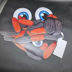 Detailed view of cartoon Halloween spider eye and leg stickers stacked together.