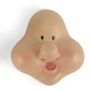 Close-up detail view of a gnome resin face accessory with small eyes and large nose for DIY dolls