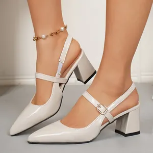 Close-up detail of cream pointed-toe slingback pumps featuring elegant block heels and buckle