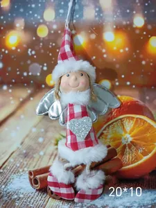 Detail view of cute Christmas angel doll with red checkered dress and silver wings