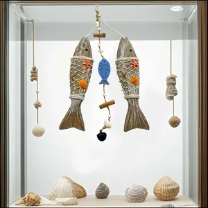 Close-up of nautical wood fish hanging ornament with starfish and real seashells