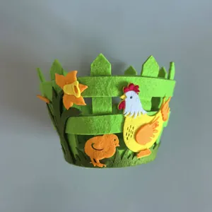 Detailed view of green non-woven felt Easter basket featuring fence design and hen motif