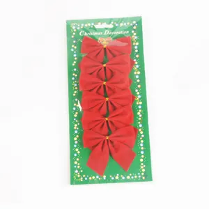 Detail of 6-piece red velvet Christmas tree bow decorations on green display card