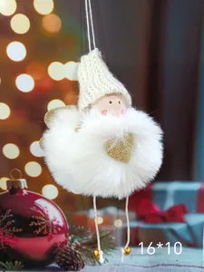 Macro detail of a plush Christmas angel ornament with white faux fur and a golden heart