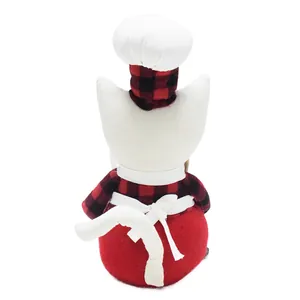 Detailed back view of handmade plush chef cat doll in red plaid shirt and white apron