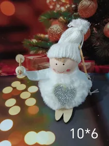 Close-up of cute white plush angel ornament with silver heart for Christmas tree