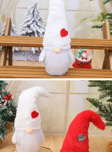 Close-up of Nordic plush Christmas gnomes with heart patterns in a festive setting