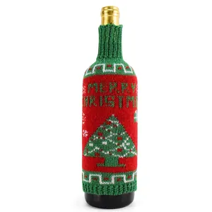 Detail view of knitted Christmas wine bottle cover with Merry Christmas tree pattern