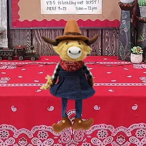 Detail view of Highland Cow plush toy in Western cowboy outfit with yellow star boots