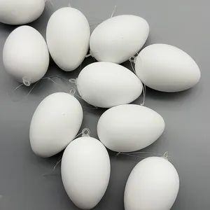 Detail view showing multiple white DIY blank Easter eggs with clear hanging loops