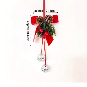 Close-up of a festive Christmas ornament with red velvet bow and silver disco balls