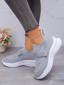 Detail van de ademende mesh sneakers met strass bandje en een dikke witte zool