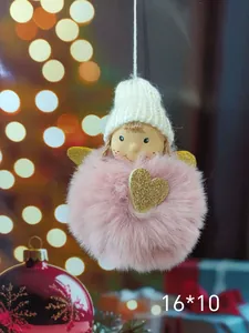 Detailed close-up view of a pink plush angel Christmas ornament with gold heart