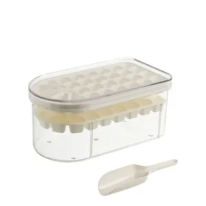 Detail view of a clear ice cube mold box with a white tray and plastic ice scoop.