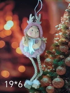 Detail of a cute pink plush Christmas angel doll ornament with antlers and stars.