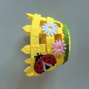 Detail view of Easter non-woven basket featuring ladybug and daisy felt decorations.