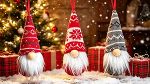 Three hanging knitted Christmas gnome dolls with white beards in a festive background