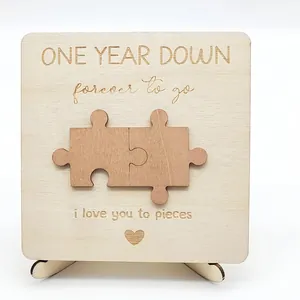 Close-up of engraved wooden anniversary plaque with puzzle pieces and romantic message