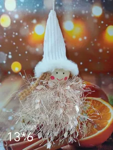 Close-up of cute Christmas angel doll ornament with white pointed hat and fuzzy dress