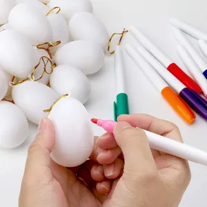 DIY white Easter egg blanks with colorful markers for creative kids' graffiti art projects