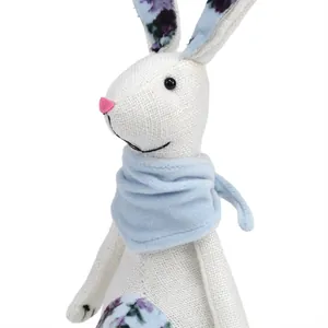 Detailed view of handmade linen Easter bunny figurine with blue scarf and floral pattern