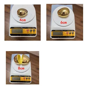 Electroplated gold plastic Easter eggs in three sizes 4cm 6cm 8cm shown on a scale