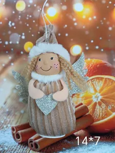 Detailed view of plush angel girl ornament with silver wings and heart