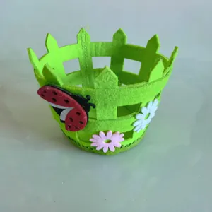 Green Easter felt basket with fence design featuring ladybug and flower decorations